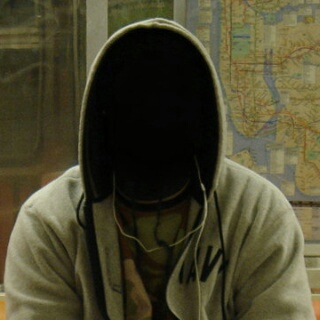 a hooded person on a subway train, their face is not visible